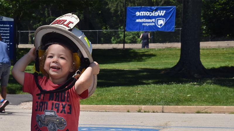 child wearing firefighter helment